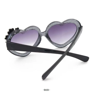 Rear view of heart-shaped kids sunglasses with grey glitter frames and purple lenses