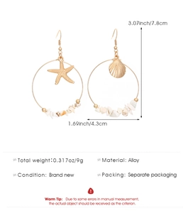 Detailed view of ocean style gold hoop earrings with starfish and seashell charms