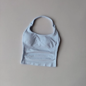 Detailed close-up of light blue halter yoga vest with built-in cups and seamless hem