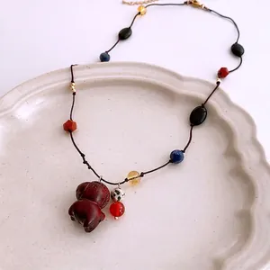 Bohemian beaded necklace featuring a hand-carved wooden horse pendant and multi-colored beads