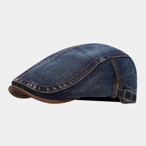 Retro denim flat cap in dark blue with orange stitching and brown leather piping detail