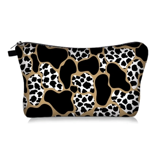 Detailed view of the cow print digital makeup bag featuring black and white patterns.