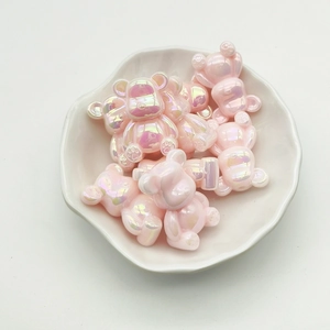 Pink gradient UV plated bear beads in a white ceramic dish for DIY jewelry making