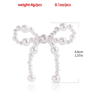 Detail showing pearl bow earrings with size measurements and lightweight 4g weight display