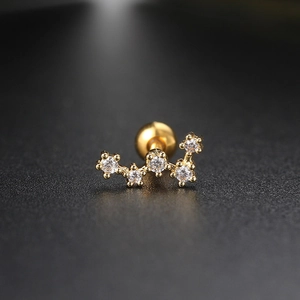 Macro shot of gold constellation ear stud featuring five sparkling inlaid zircons