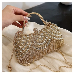 Detailed view of luxury gold rhinestone evening bag with elegant metal handle and chain