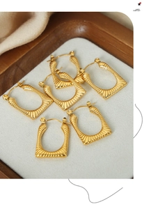 Detail view of 18K gold plated titanium steel earrings with textured radial patterns