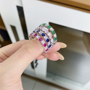 Close-up of stacked S925 sterling silver rings with colorful candy-toned gemstones