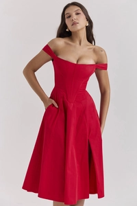 Detail of red satin dress featuring an off-shoulder neckline and a high-slit elegant design