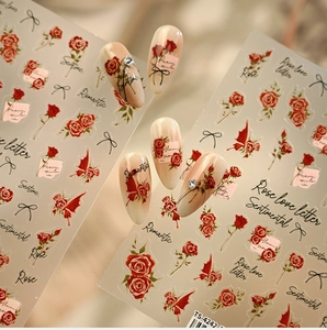 Close-up of TS-4242 rose nail stickers with black bows and elegant script designs