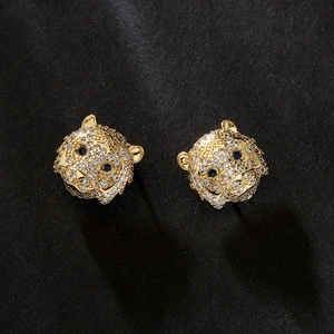 Gold plated tiger head stud earrings with micro paved zircons and blue gemstone eyes