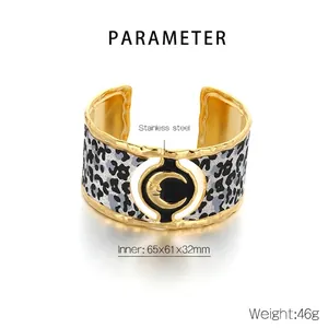 Detail view of leopard print stainless steel cuff with golden crescent moon and dimensions
