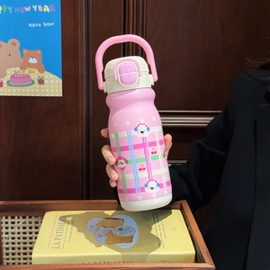 Close-up of pink stainless steel thermal cup with bear patterns and portable handle