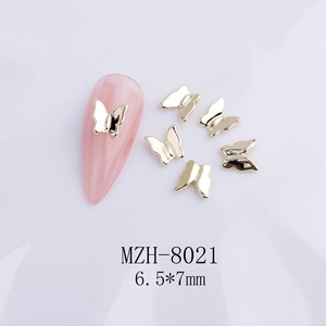 Detail of golden metal bow nail charms style MZH-8021 sized 6.5x7mm for 3D nail art