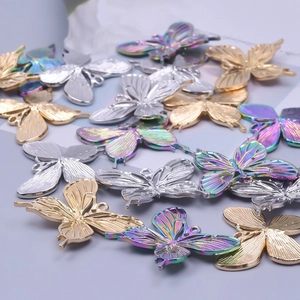 Polished butterfly jewelry pendants in gold, silver, and rainbow finishes for DIY crafts