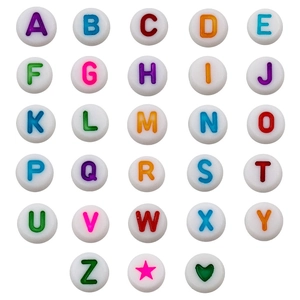 Macro view of white acrylic beads featuring letters A-Z and decorative star icons
