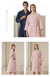 Detailed view of waffle texture fabric and elegant white piping on hotel style bathrobe