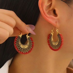 Bohemian retro hollow carved earrings with vintage gold metal and red woven rope detail
