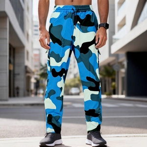 Men's blue camouflage cargo pants with drawstring waist and tapered cuffs in urban setting