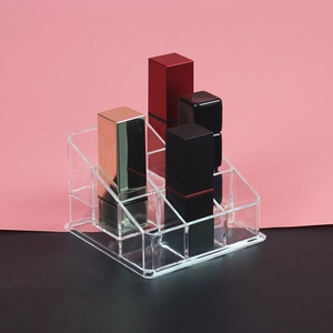 Close-up of clear acrylic lipstick holder with multi-slot tiered organizer design
