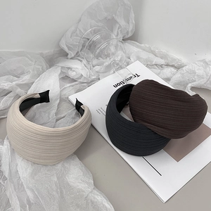 Classic wide pleat headbands in beige black and brown colors shown on fashion magazine