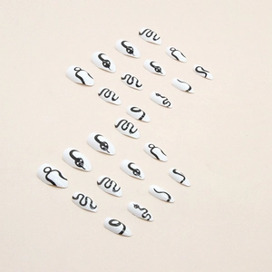 Minimalist stiletto press-on nails with black snake pattern on white almond shape