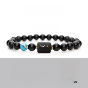 Macro shot of Sagittarius zodiac bracelet with matte black beads and engraved logo