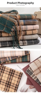 Detailed view of Scottish plaid scarves with fringe in assorted colors and gift packaging