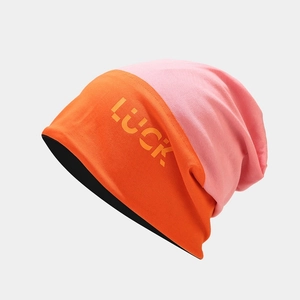 Close-up of contrast color knit beanie with yellow LUCK letter embroidery detail