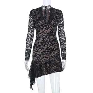 Close-up of the delicate black lace fabric and asymmetrical hemline of the V-neck dress
