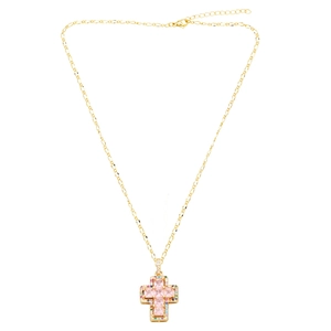 Close-up of golden cross necklace with pink square gemstones and multicolored pavé crystals