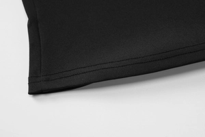 Detailed close-up of the hem stitching and fabric texture on a black slim-fit camisole top