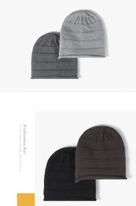 Detailed texture of thick knitted winter beanies in grey, black, and coffee colors