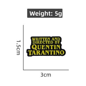 Detailed view of Quentin Tarantino enamel pin with 1.5cm by 3cm size measurements