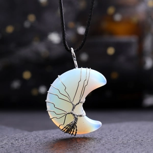 Macro detail of moon-shaped opal pendant with silver tree of life wire wrapping