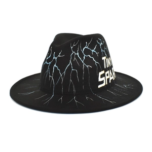 Detail of black wool fedora with light blue lightning patterns and Tiny Spark lettering