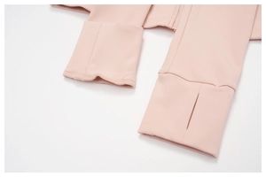Detail view of pink sports jacket cuffs with thumbholes and high-quality flat stitching