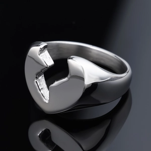 Minimalist stainless steel broken heart ring with reflective silver finish on black background