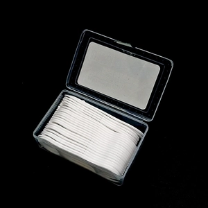 Bulk disposable dental floss picks in a transparent plastic organizer box with black background