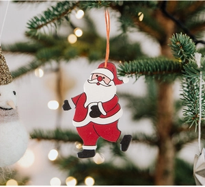 Detailed view of a hand-painted wooden Santa Claus ornament hanging on a festive Christmas tree
