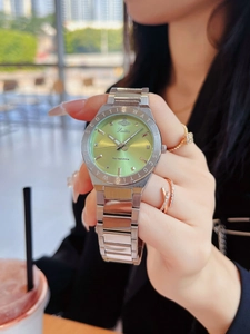 Close-up of a silver ladies' watch featuring a light green sunray dial with crown logo