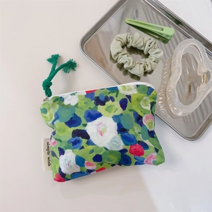Detailed macro view of oil painting style canvas coin purse with green floral print
