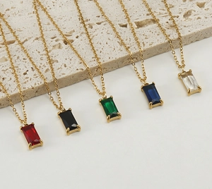 Detail showing square zircon necklaces in red, black, green, blue, and clear white colors