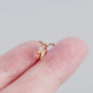 Macro shot of minimalist s925 silver lightning stud earrings with cubic zirconia stones