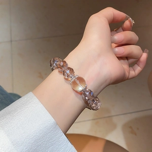 Macro shot of champagne cat eye crystal beaded bracelet with faceted stones on wrist