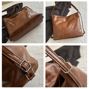 Detail view of brown vintage leather tote with silver metal hardware and zip pocket
