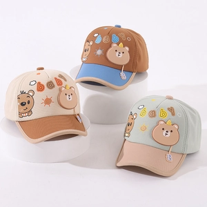 Detailed view of three baby baseball caps with 3D bear patches and baby embroidery