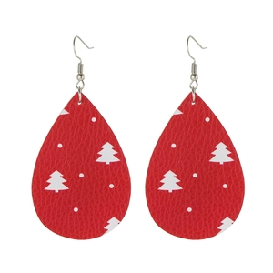 Detail view of red teardrop faux leather earrings with white Christmas tree patterns