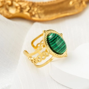 Detail view of oval malachite stone ring with vintage gold hollow braided texture