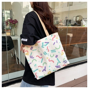 Casual canvas tote bag featuring colorful abstract geometric patterns on a shoulder strap
